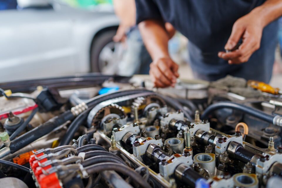Mechanic working on a car engine, illustrating the concept of a funded revocable living trust