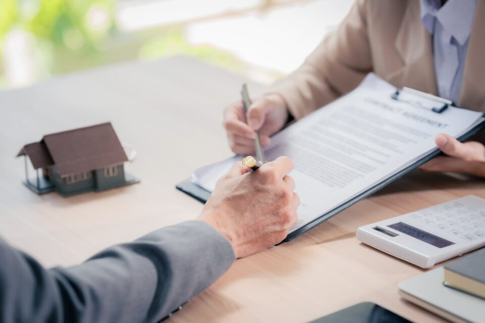 hands signing papers