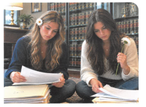 Two teenagers looking at papers